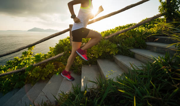 istock Determined woman running up on seaside mountain stairs 1018151662