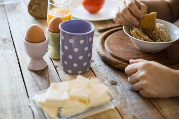 istock Breakfast at dining table - boiled eggs, mortadella, soft cheese, yogurt and fruit juice 1018151742