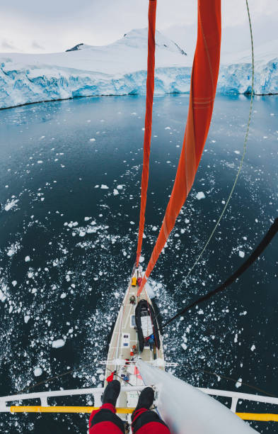 sailor standing on mast of sailing boat yacht in Antarctica, adventure travel sailor standing on mast of sailing boat yacht in Antarctica, adventure travel expedition yacht selfie stock pictures, royalty-free photos & images
