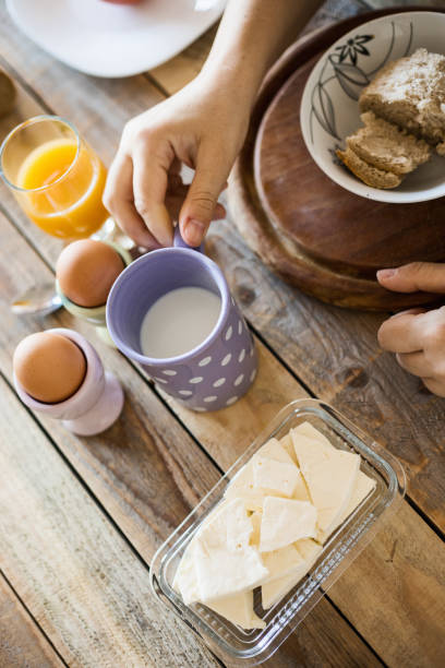 istock Breakfast at dining table - boiled eggs, mortadella, soft cheese, yogurt and fruit juice 1018152174
