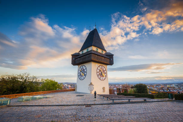 Graz clock tower at sunset, Graz, Styria, Austria Classic view of famous Grazer Uhrturm in the historic city of Graz in beautiful evening light at sunset, Styria, Austria clock tower stock pictures, royalty-free photos & images