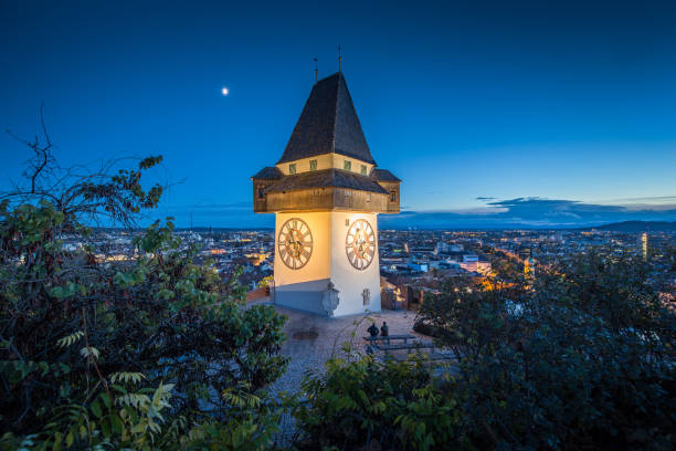 graz clock tower at night, styria, austria - graz austria clock tower styria imagens e fotografias de stock