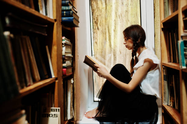 istock Girl with pigtails in white blouse at old library. 1018158508