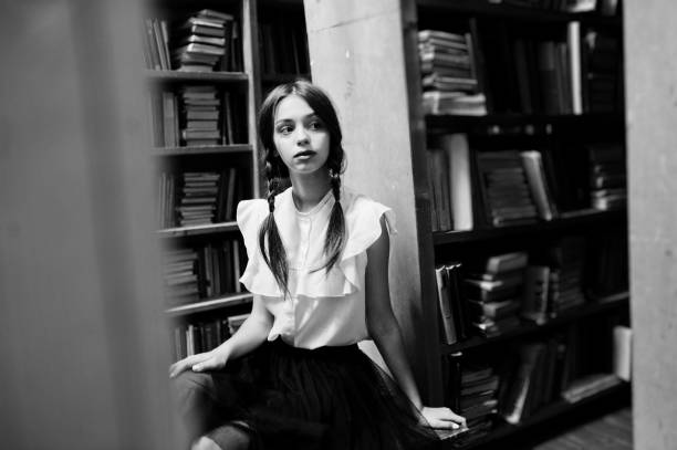 istock Girl with pigtails in white blouse at old library. 1018158546
