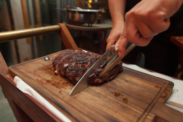 istock Cutting grill beef on wooden cutting board in the restaurant for dinner. 1018158612