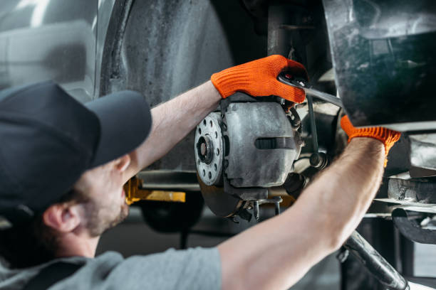 istock professional auto mechanic repairing car without wheel 1018159342