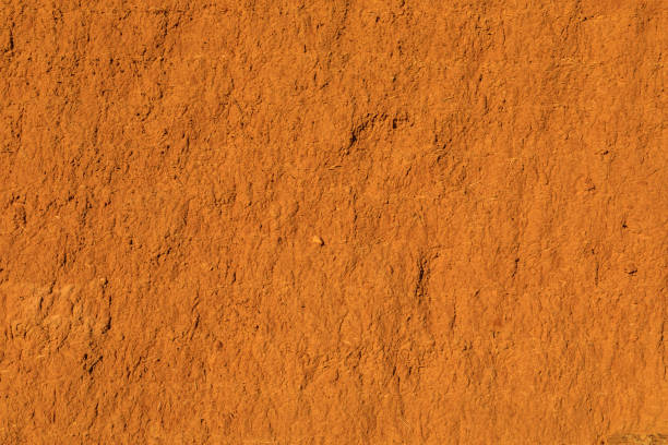 istock Wall of adobe, earth, mud, straw, pressed. Old, traditional and sustainable construction. Eroded by the passage of time and weather. 1018162224