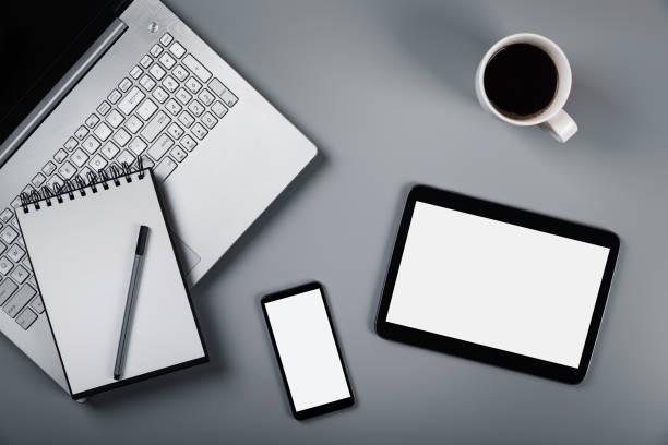 istock mockup with laptop phone and digital tablet on gray background. top view 1018164364