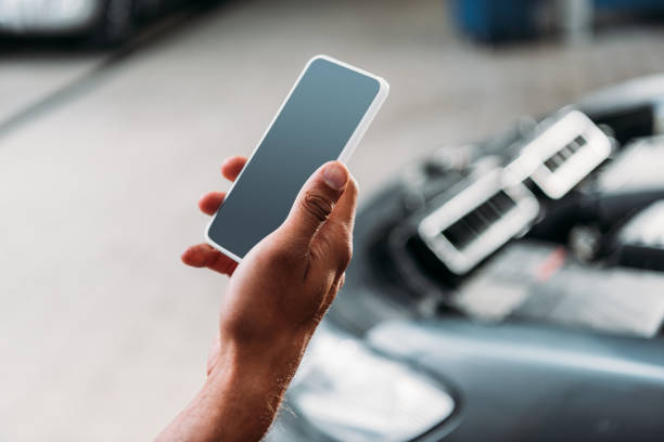 istock partial view of worker using smartphone with blank screen in mechanic shop 1018168696