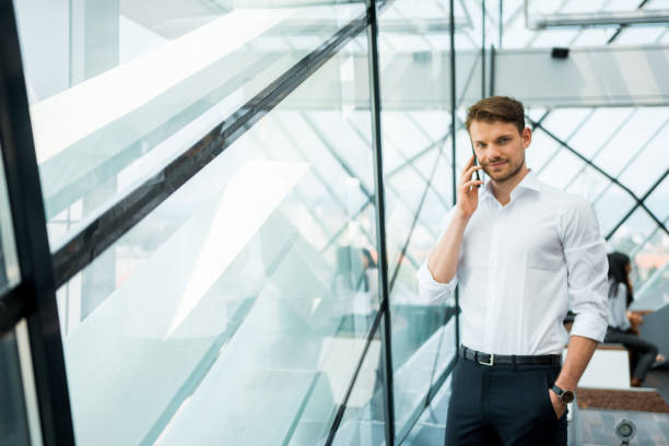 istock Businessman using a smart phone in the office next to the window 1018169428