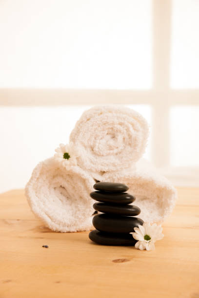 istock Towels and masage rocks on table in spa salon 1018176318