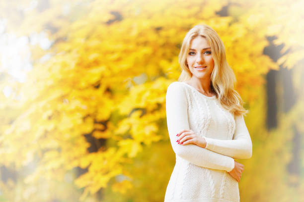 istock woman walking outdoors in autumn park 1018185030