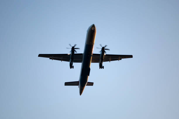 istock Silhouette of landing airplane - low-angle view 1018188092