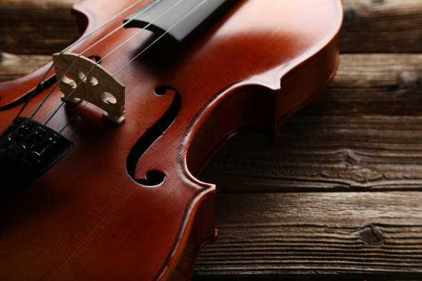 istock Violin on brown wooden table 1018188186