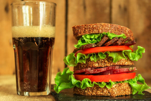 istock sandwich (sausage, bread, lettuce, tomatoes and more) . food background.  Top view with copy space 1018188414