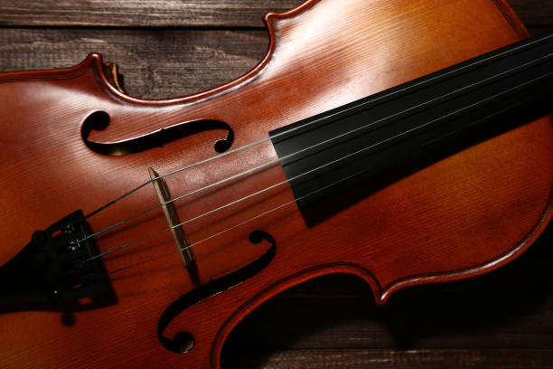 istock Violin on brown wooden table 1018188496