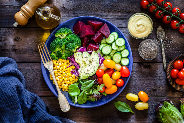 istock Salad mix plate shot from above on rustic wooden table 1018199374