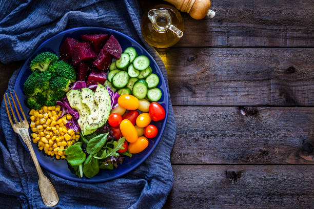 istock Salad mix plate shot from above on rustic wooden table 1018199402