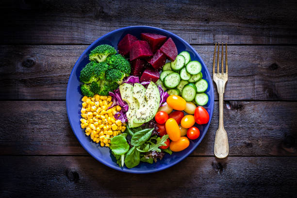 istock Salad mix plate shot from above on rustic wooden table 1018199524
