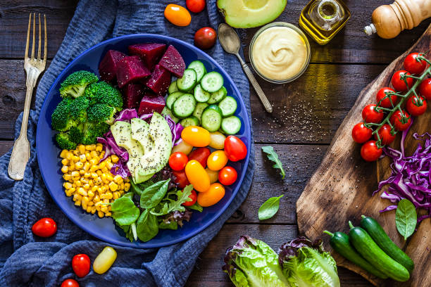 istock Salad mix plate shot from above on rustic wooden table 1018199546