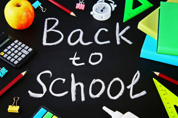 istock School and office supplies on a black chalkboard background. Back to school. 1018202162