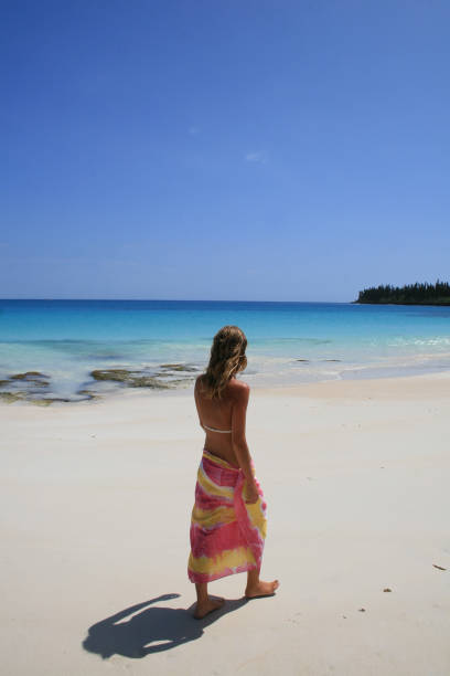 istock Woman walking on the beach 1018203142