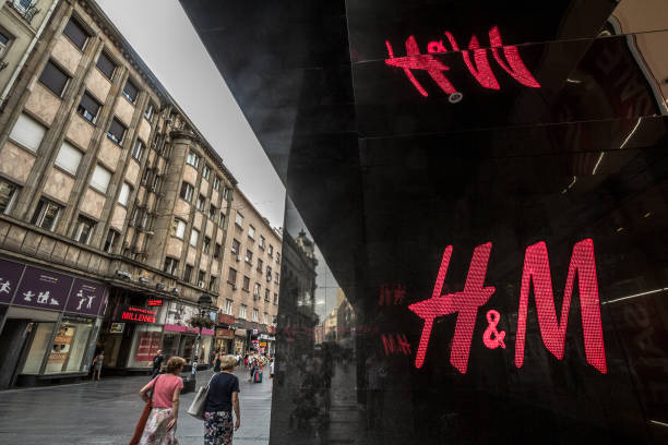 Logo of H&M on their main store for the Serbian capital city. H&M is one of the biggest fashion retail brand in the world Picture of the logo of H&M taken in Serbia, with pedestrians passing by. H & M, or Hennes & Mauritz is a Swedish multinational clothing-retail company, known for its fast-fashion clothing. h and m stock pictures, royalty-free photos & images