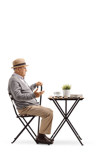 istock Mature man sitting at a coffee table and talking 1018211520