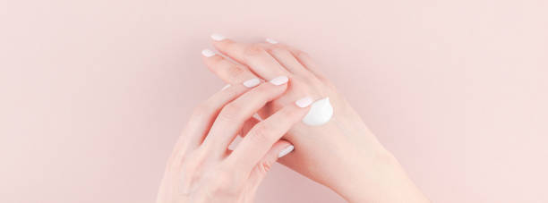 istock Woman moisturizing her hand with cosmetic cream 1018214466