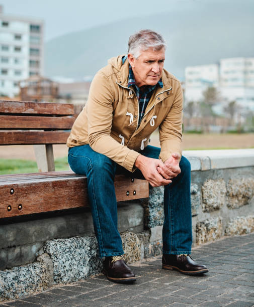 He's having one of those days Full length shot of a senior man looking depressed while sitting on a bench near the beach sitting on bench stock pictures, royalty-free photos & images