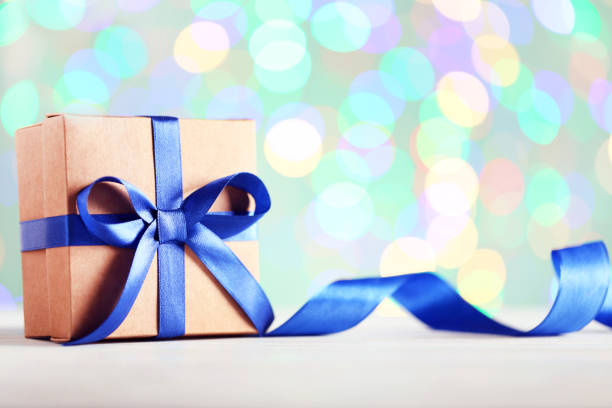 istock Gift box with ribbon on lights background 1018217760