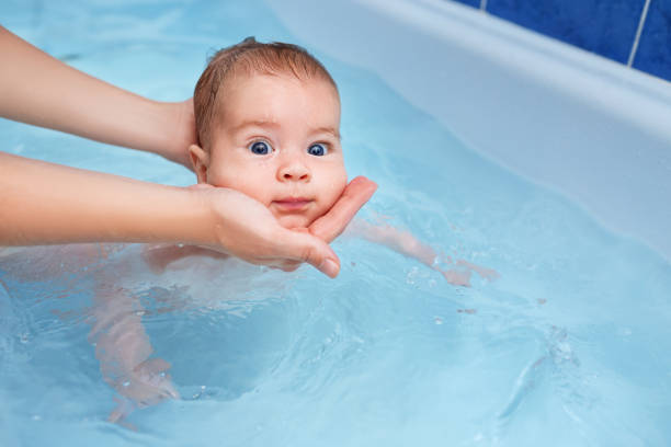 istock baby boy swimming in the bath 1018218732