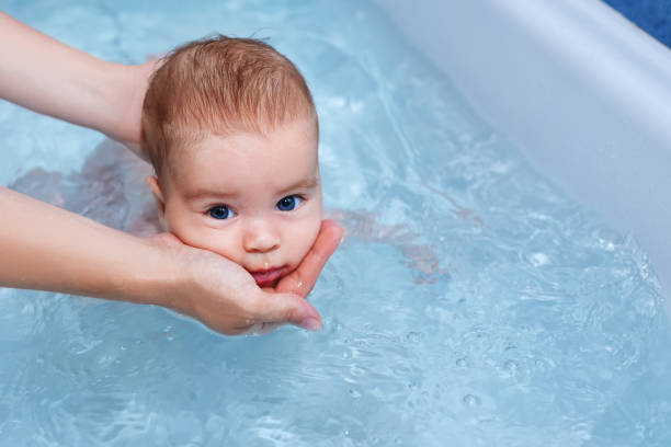 istock baby boy swimming in the bath 1018219304