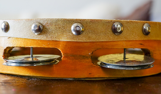 An up close view of the side of a tambourine