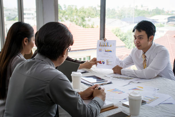 istock Asians executive businessman and adviser discussing and working together with reports on table at office 1018221862