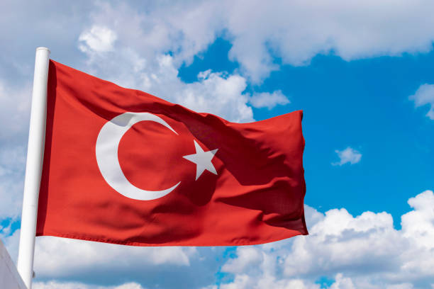 istock Turkish Flag waving with cloudy blue sky background 1018222294