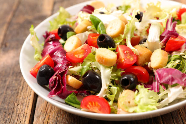 istock vegetable salad on wood background 1018222322