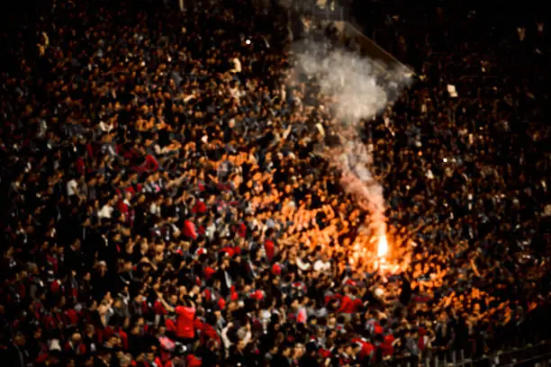 Photo of Naked football fans cheer their soccer team score goal with the fire at the stadium
