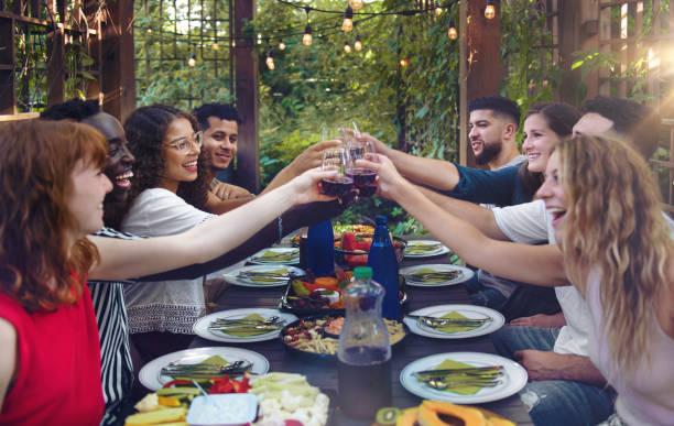 istock Multi-ethnic friends enjoying dinner together 1018226014