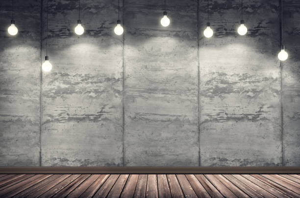 istock Grungy concrete interior room with many light bulbs. 1018231946