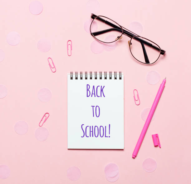 istock Notebook or notepad with glasses on pink backgriund 1018232310