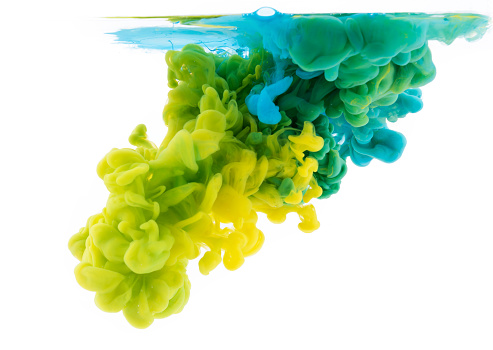 Yellow and green paint dissolving into water, abstract background
