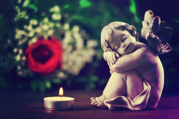 istock Angel and burning candle 1018237586
