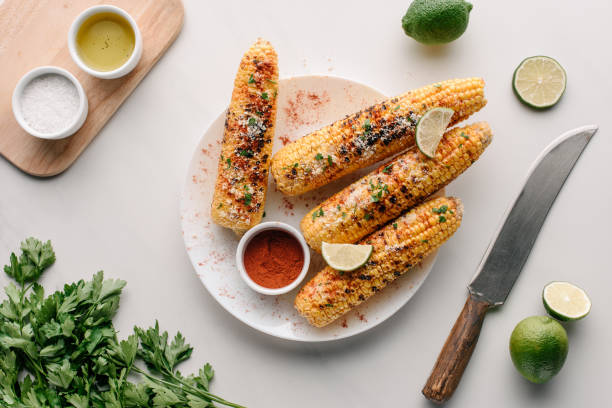 istock top view of grilled salted corn with lime slices and chili spice on table 1018238196
