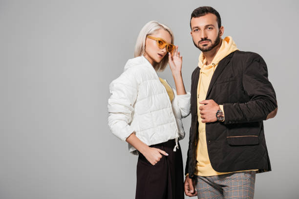 istock couple of models in autumn jackets posing isolated on grey background 1018241632