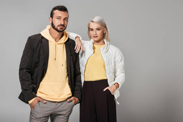 istock couple dressed in stylish autumn clothes posing isolated on grey background 1018241690