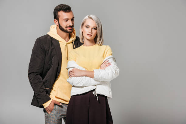istock stylish couple of models posing isolated on grey background 1018242006