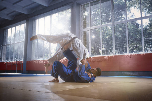 istock Two judo fighters showing technical skill while practicing martial arts in a fight club 1018242336