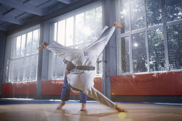 istock Two judo fighters showing technical skill while practicing martial arts in a fight club 1018242918