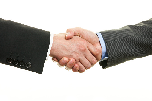 Two businessman shaking hands. Handshake concept for successful cooperation and deal making.